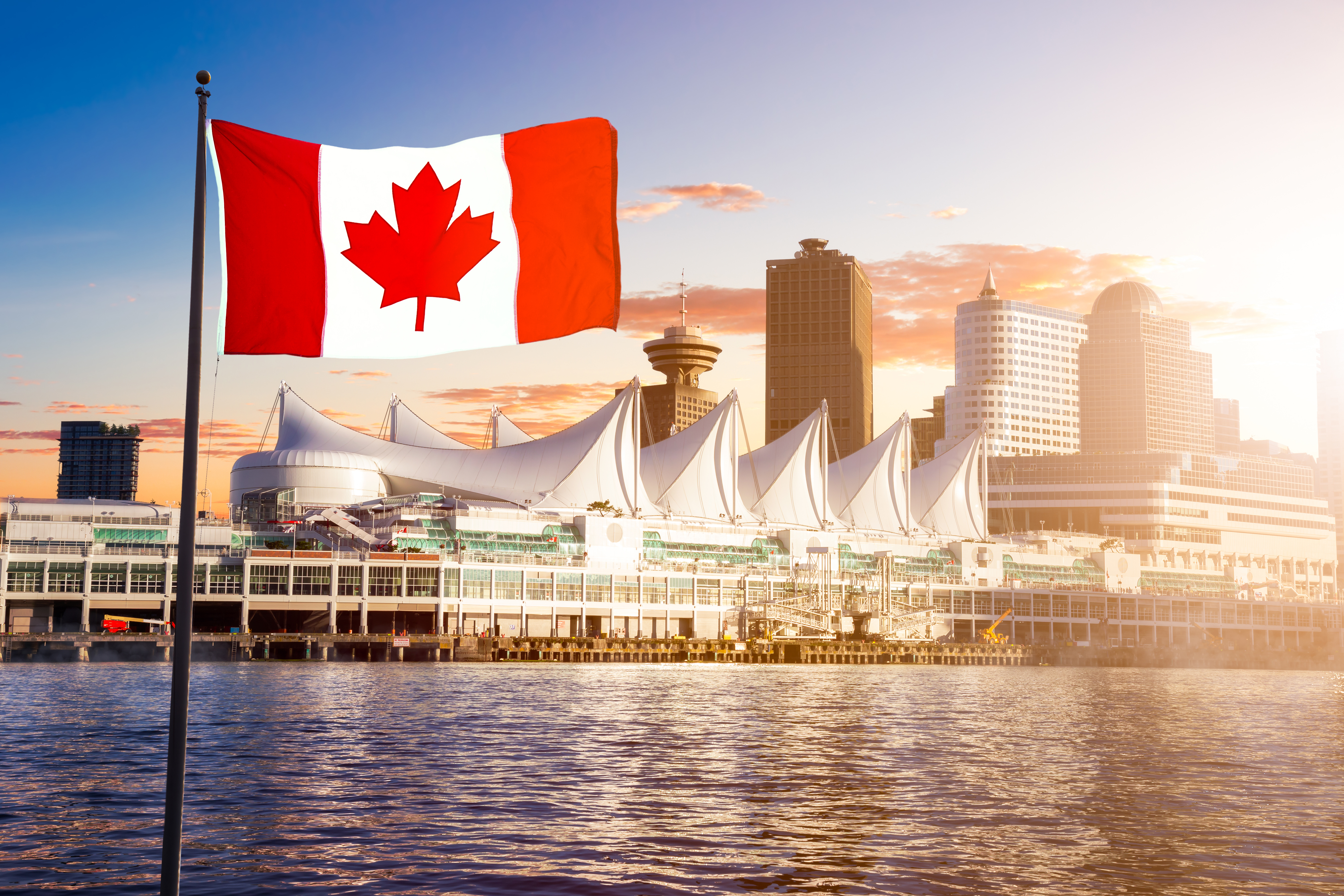 Canadian flag on the background of the city, which is suitable for immigration to Canada
